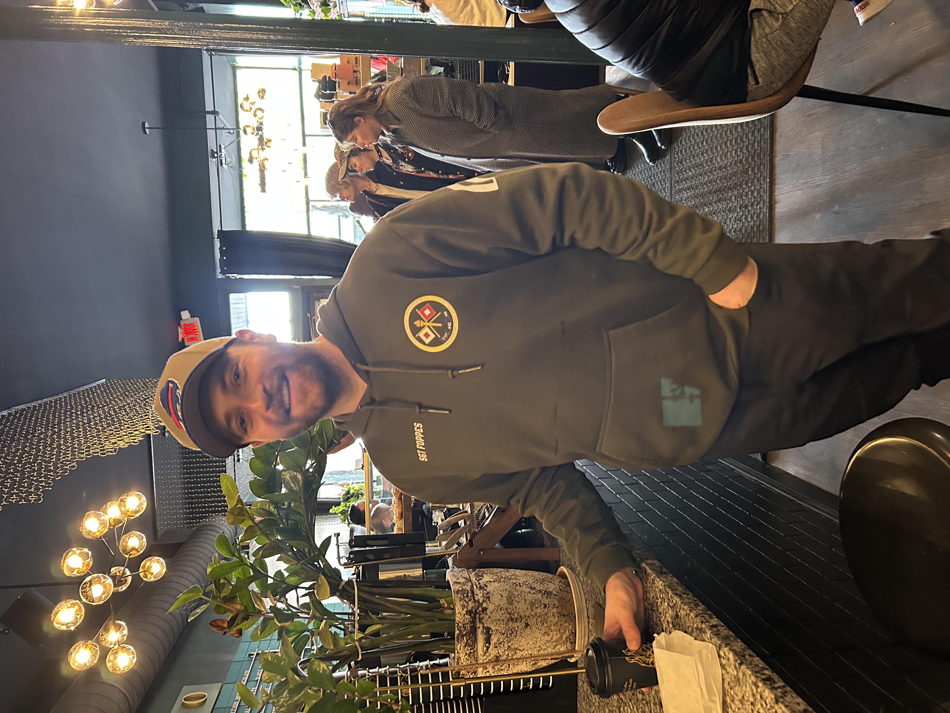 Photo Of Jacob Standi ng with a cofee